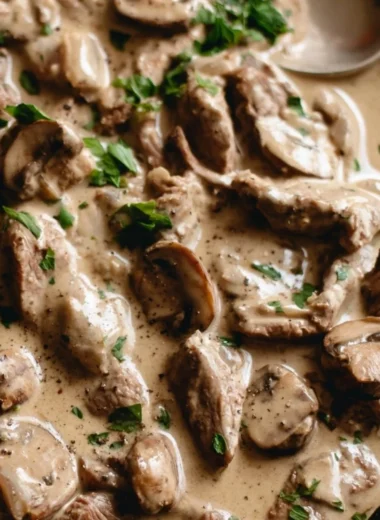 A delicious plate of Beef Stroganoff served with egg noodles and garnished with parsley.