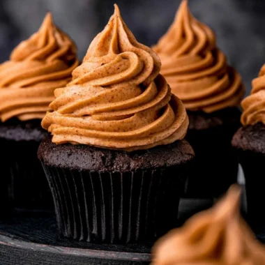 Delicious chocolate pumpkin cupcakes topped with creamy frosting