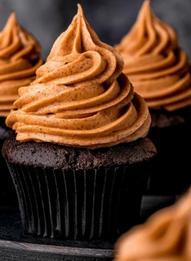 Delicious chocolate pumpkin cupcakes topped with creamy frosting