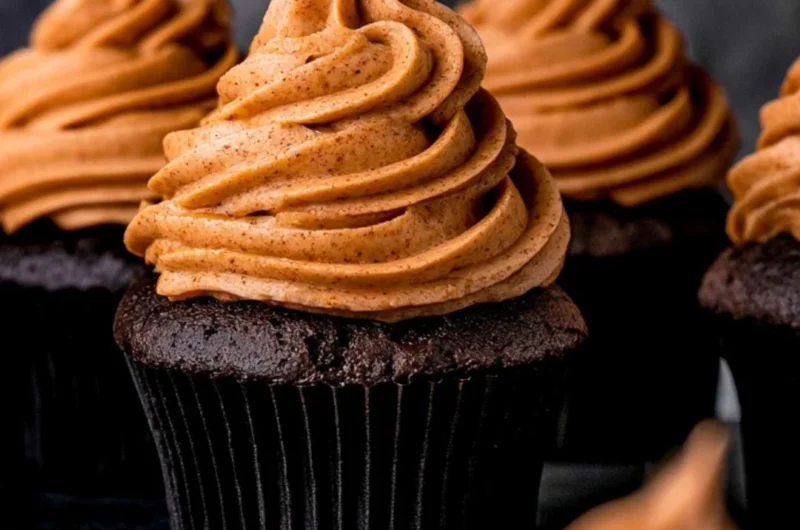 Delicious chocolate pumpkin cupcakes topped with creamy frosting