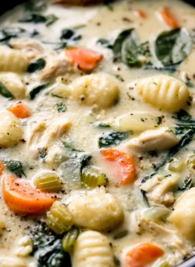 Crockpot Chicken Gnocchi Soup served in a bowl with fresh herbs