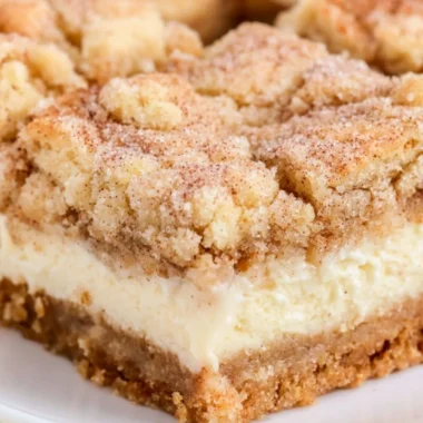 Delicious Snickerdoodle Cheesecake Bars topped with cinnamon sugar