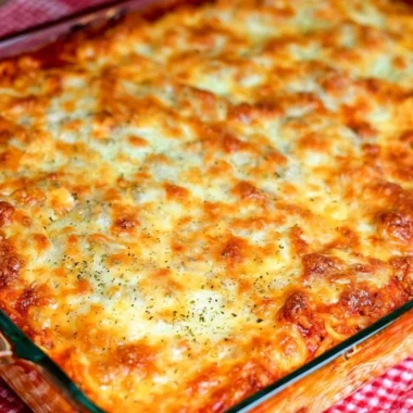 Delicious Ultimate Baked Spaghetti topped with cheese and herbs
