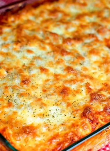 Delicious Ultimate Baked Spaghetti topped with cheese and herbs