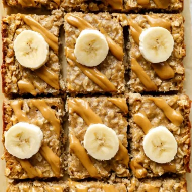 Bowl of easy peanut butter baked oatmeal topped with bananas and honey.
