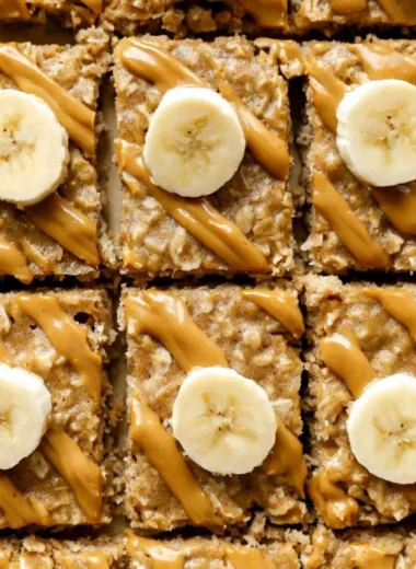 Bowl of easy peanut butter baked oatmeal topped with bananas and honey.