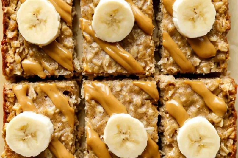 Bowl of easy peanut butter baked oatmeal topped with bananas and honey.